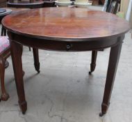 A late 19th century mahogany extending dining table of oval form with a wind out action on square