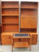 A pair of G Plan teak wall units together with a trolley