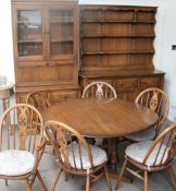 An Ercol dining room suite comprising a drop leaf table, six chairs, together with a Dutch dresser,