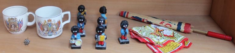 A Robertsons Gollywog band together with a paper parasol,