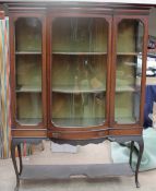 An Edwardian mahogany display cabinet with a central glazed door,