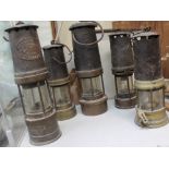 A Thomas and Williams miner's lamp together with four other miner's lamps