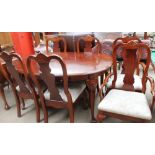 A reproduction walnut extending dining table with two leaves and six chairs including two carvers