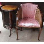 A small tripod table together with a bergère chair