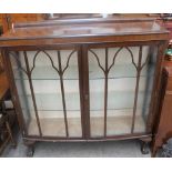 A 20th century mahogany display cabinet together with a teak sideboard