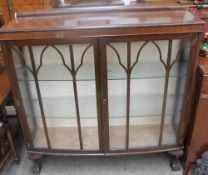 A 20th century mahogany display cabinet together with a teak sideboard