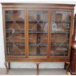 A George III style mahogany bookcase with a moulded cornice,