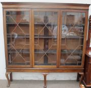 A George III style mahogany bookcase with a moulded cornice,