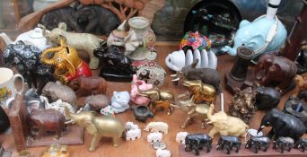 A collection of elephant figures, together with collector's plates,