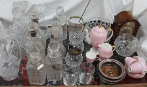 A pair of silver topped and glass decanters together with other glass decanters, glasses, bowls,