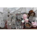 A pair of silver topped and glass decanters together with other glass decanters, glasses, bowls,