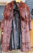 A Full-length fur coat together with other coat