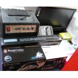 A collection of new and used boxed appliances including a Sharp flat screen television together