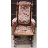 An upholstered American rocking chair and a modern teak display cabinet