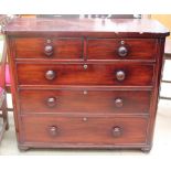 A Victorian mahogany chest of drawers on turned feet