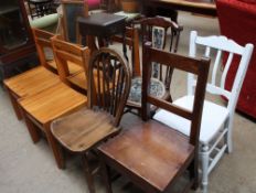 A set of four pine dining chairs together with a white painted kitchen chair,
