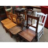 A set of four pine dining chairs together with a white painted kitchen chair,