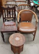 An oak elbow chair together with a set of four stick back dining chairs,