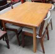 A Danish teak draw-leaf extending dining table together with a set of four chairs