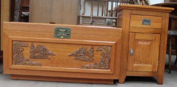 A 20th century Chinese carved coffer together with a pine bedside cabinet