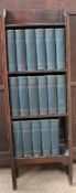 A small oak bookcase with seventeen volumes of the Charles Dickens Library