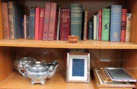 A silver photograph frame together with electroplated wares, books,