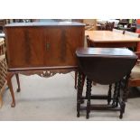 A 20th century walnut cocktail cabinet together with a small oak drop leaf table