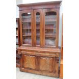 A Victorian mahogany bookcase with a moulded cornice and three glazed doors,