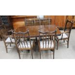 A 20th century oak dining suite comprising an extending dining table,