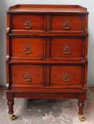 A reproduction mahogany waterfall chest of drawers