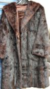 A dark brown three quarter length fur coat