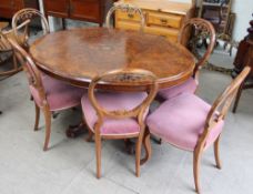 A Victorian burr walnut oval topped supper table together with six Victorian balloon back dining
