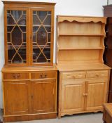 A modern pine kitchen dresser together with a modern yew bookcase