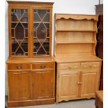 A modern pine kitchen dresser together with a modern yew bookcase