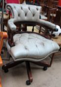 An upholstered captains chair
