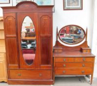 An Edwardian mahogany three-piece bedroom suite comprising a wardrobe,