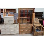 A painted wicker chest of drawers together with a matching bedside cabinet, a wicker bookshelf,