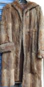 A light brown three quarter length fur coat