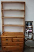 A pine chest of drawers together with a pine bookcase and three gilt framed wall mirrors