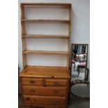 A pine chest of drawers together with a pine bookcase and three gilt framed wall mirrors