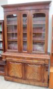 A Victorian mahogany bookcase with a moulded cornice and three glazed doors,