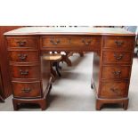 A 20th century burr walnut pedestal desk with a shaped leather inset top