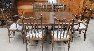 A 20th century oak dining suite comprising an extending dining table,