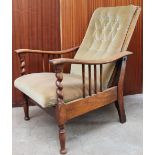 An Arts and Crafts style oak framed reclining elbow chair