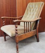 An Arts and Crafts style oak framed reclining elbow chair