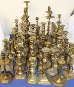A large assortment of brass candlesticks etc