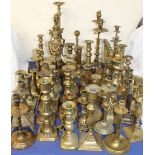 A large assortment of brass candlesticks etc