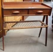 A Danish teak side table with a rectangular top and three-quarter gallery with two drawer above a