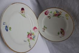 A pair of Swansea porcelain plates, painted with sprays and individual flowers to a gilt rim,