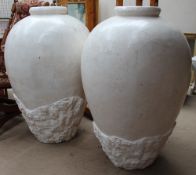 A large pair of simulated marble floor vases
